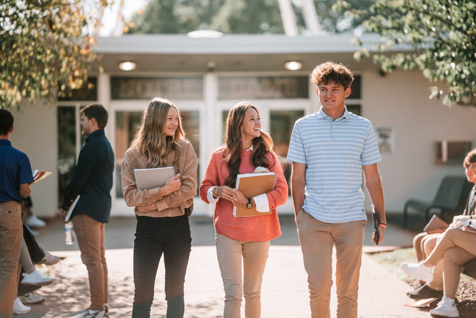 QND students walking and chatting on campus, representing student life at Quincy Notre Dame High School